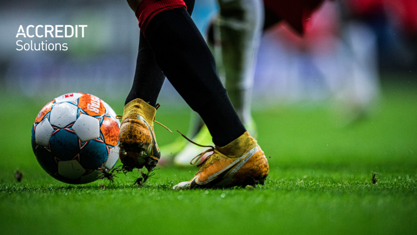 A footballer kicking a ball. 